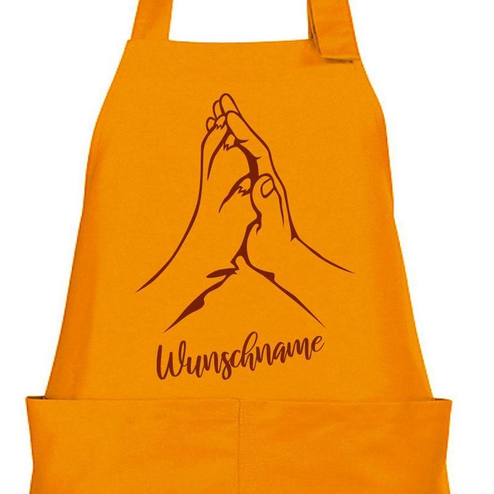 Orange Kochschürze mit Hand und Pfote als Motiv und Wunschname
